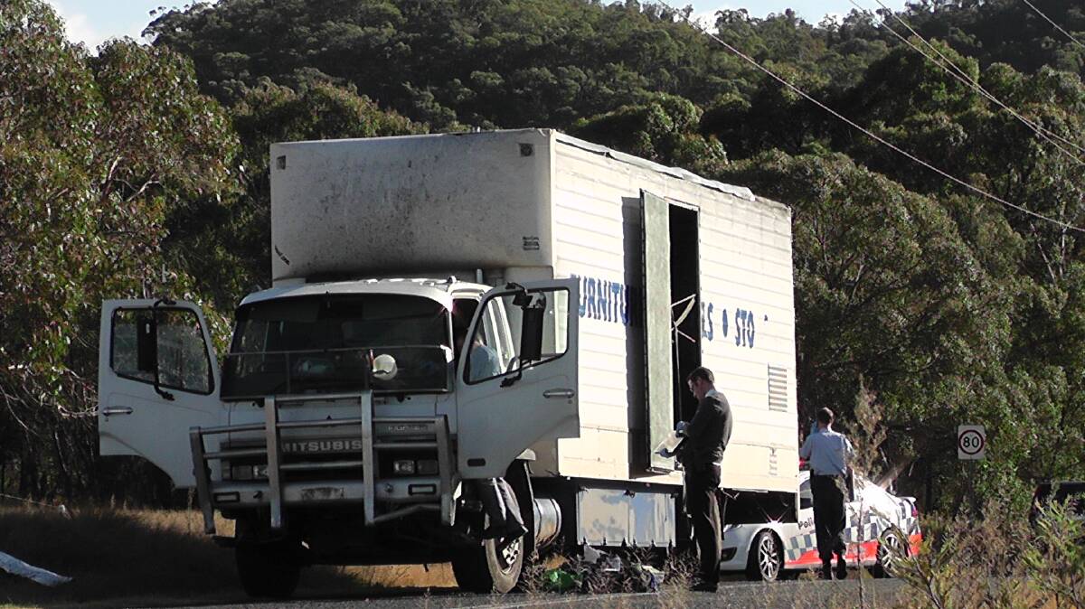 Detectives examine the truck this morning. Photo: Andrew Micallef