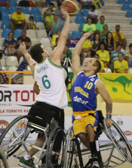 A CHAMPION IN TWO SPORTS: Michael Auprince in action in a wheelchair
basketball match.