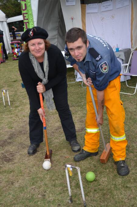 THIS IS HOW IT’S DONE: Croquet vice president Cindy Walker shows Portland Rural
Fire Service member Mick Hughes the finer intricacies of the game.