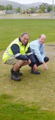 INSPECTION: Cricket secretary Neil Hutchinson and
council’s Terry Nolan inspect the pitch.