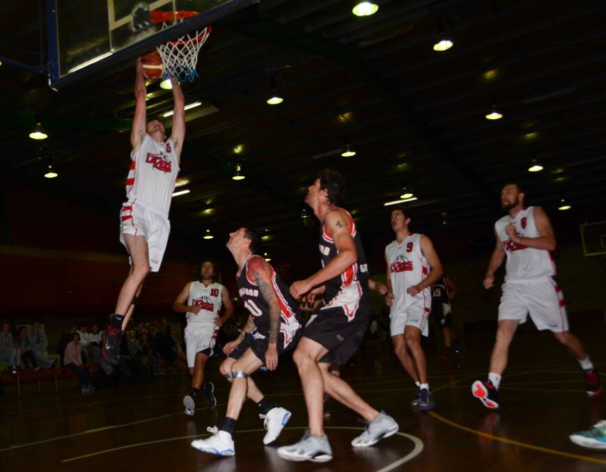 HIGH FLYER: Jon Fenton brings the crowd alight with a great slam dunk.