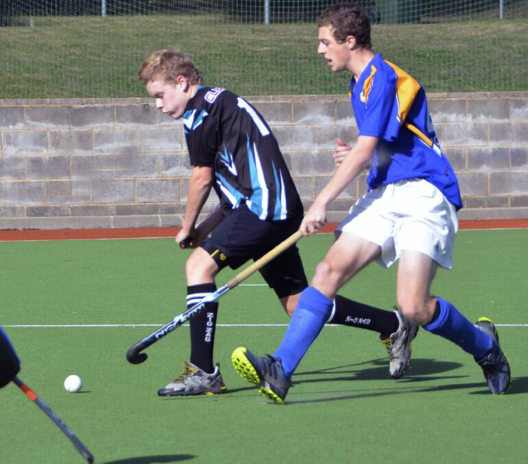 GOOD PROSPECTS: Ziggies’ Hayden Pettitt loads up for a shot on goal as Workies’ Sam Hamment moves in in defence.