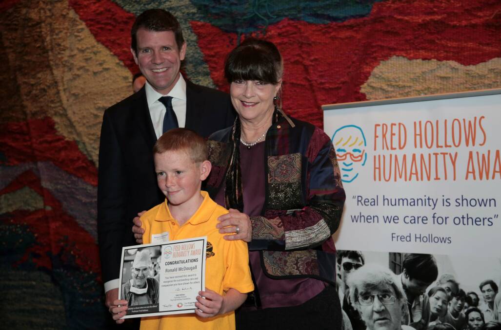 A RARE HONOUR: Terry McDougall receives his award from Gabi Hollows (Fred Hollows widow and one of Australia’s living treasures) and NSW Premier Mike Baird. 	lm092915terry