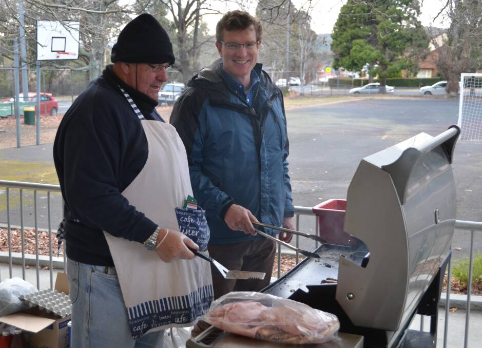 DEMOCRACY SAUSAGE: Michael Officen with Nationals' Calare candidate Andrew Gee working the barbecue at Cooerwull Public. PHOTO: Jacob Gillard.