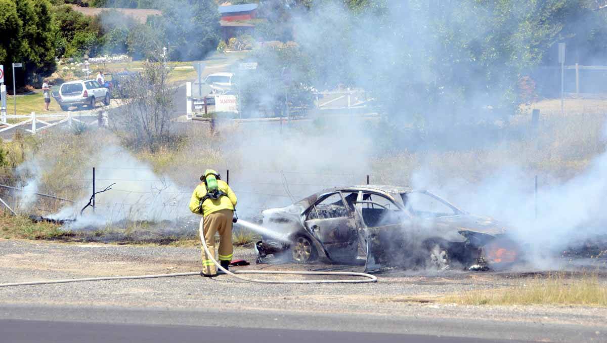 Firefighters had to control a burning car and a rapidly spreading grass fire following an incident at Marrangaroo on Sunday