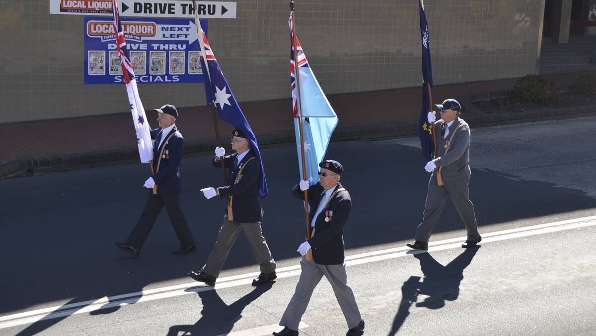 LITHGOW ANZAC DAY: Carrying the flags in the march down Main Street