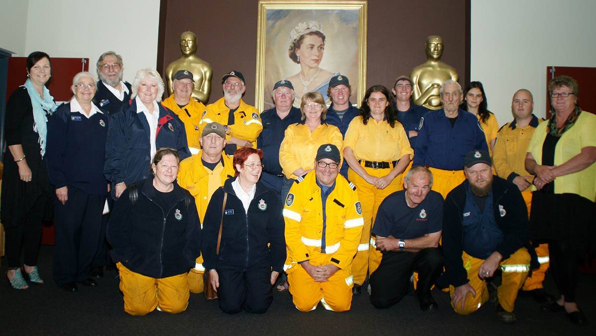 Janelle Johnstone and Sally Taylor (standing left and right) with RFS and other volunteers. 	lm112213firelight1628