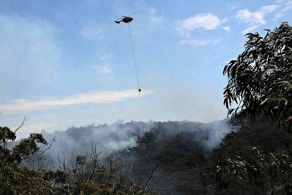 Water choppers work near Bargo ,a town close to the current fires which may threaten the small rural town of NSW if winds pick up later this evening. Photo: Brendan Esposito