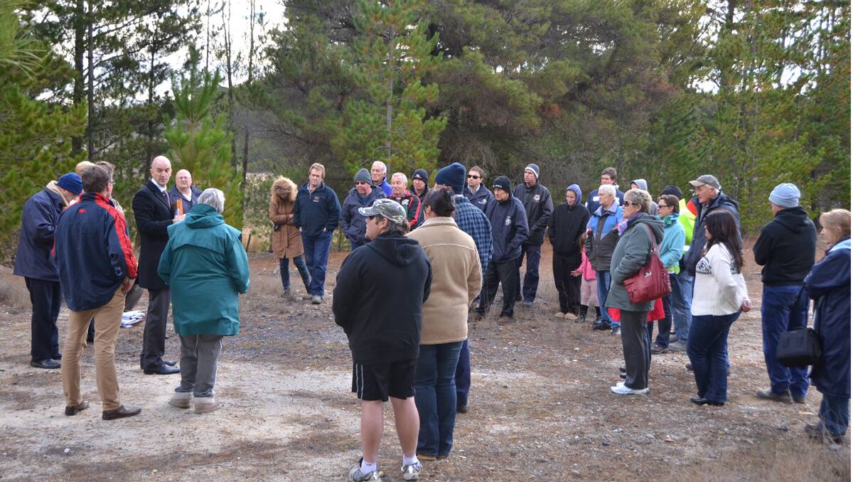 COMPANY BOWS TO PEOPLE POWER: Residents and key players braved freezing conditions for an on site meeting to debate the pros and cons of a planned national broadband tower at Lidsdale. 	lm082213LA5417