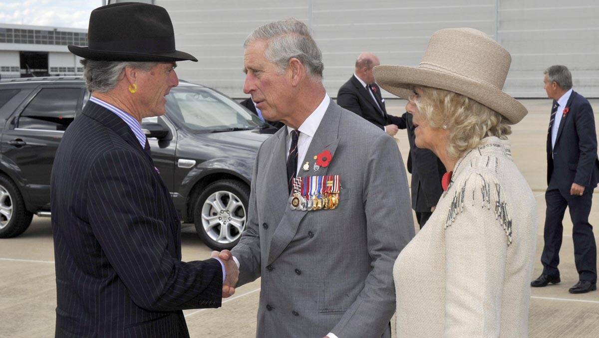 ADMIRED: Warwick Fuller gets the handshake of approval from Prince of Wales and the Dutchess of Cornwall. PHOTO: David Foote, AUSPIC 	lm111412royalartist