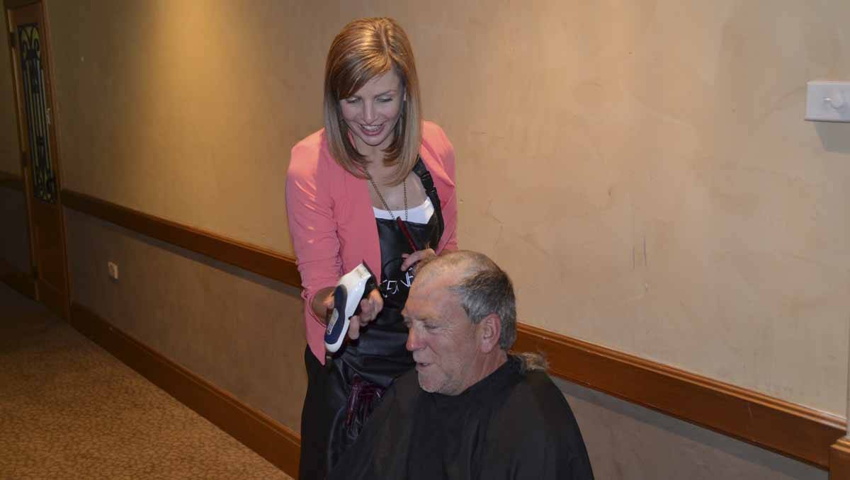 Hairdresser Sarah Burton shaves Ron Evans.