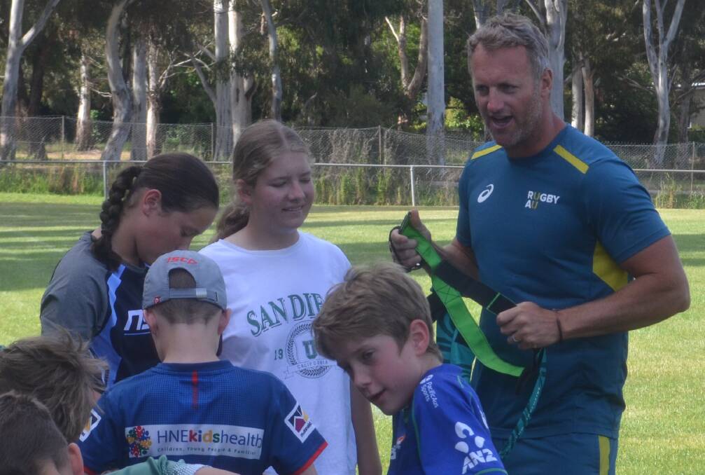 Mark Gasnier shows the kids at Emus Rugby Club the basics of his Tri Tag Rugby game. Picture by Dominic Unwin