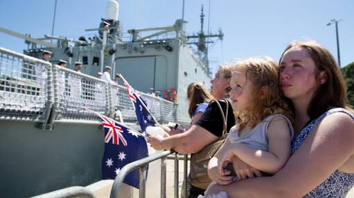 Ms Hinton with daughter Isabelle as Ben leaves for deployment. Picture: Supplied