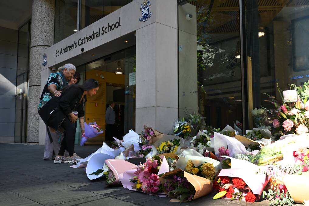 Parents, teachers and members of the public lay flowers at the entrance to St Andrews Cathedral School in the Sydney CBD, Monday, October 30, 2023. Picture by Dean Lewins/AAP Image 