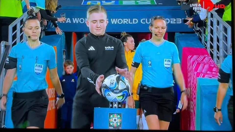 Harry Kelly about to carry the game ball for the Matildas VS Belgium game. Picture supplied. 