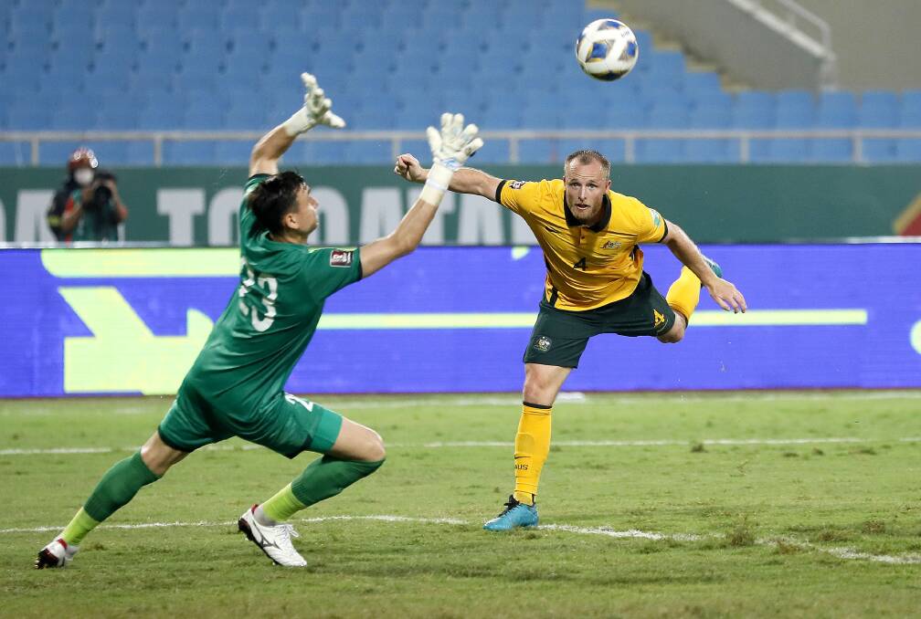 GOAL: Rhyan Grant heads the ball past Vietnamese goalkeeper Dang Van Lam in Hanoi on Tuesday night. Photo: ASIAN FOOTBALL CONFEDERATION