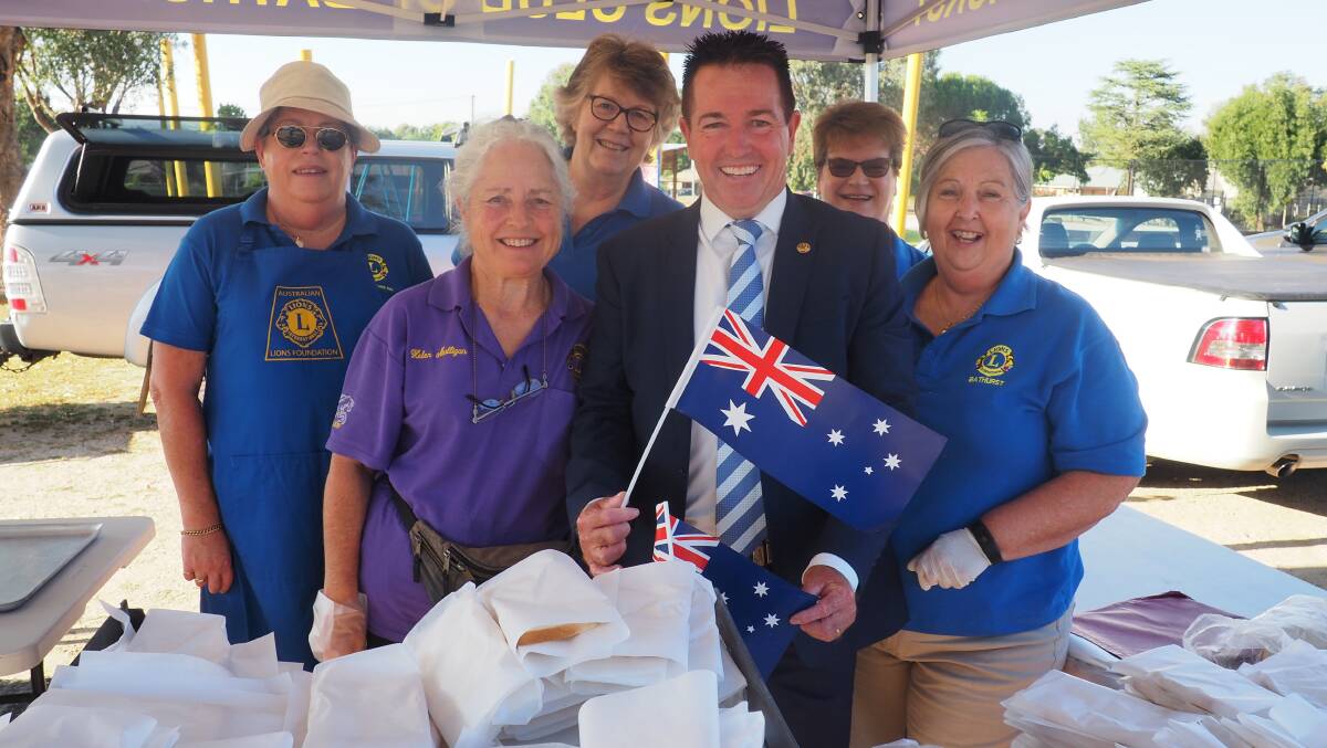 Celebrate: Paul joins Lions Club Volunteers to celebrate over an Aussie sausage sizzle.