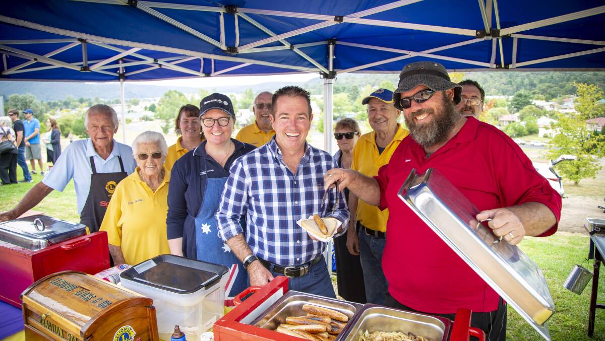 Paul grabs a sausage sanga from Lithgow Lions Club volunteers.