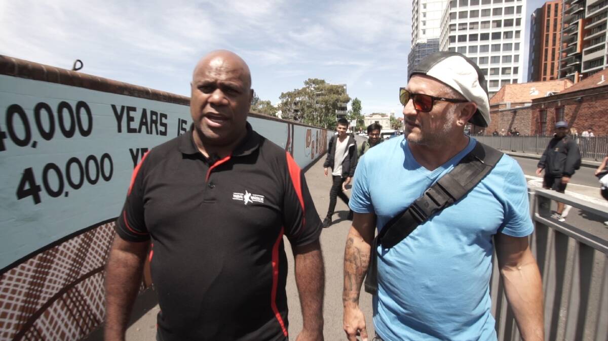 Grant Saunders (right) speaks with community leader Shane Phillips about Redfern Uprising.