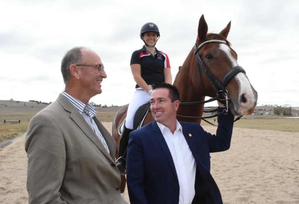 ALL SMILES: Blayney mayor Scott Ferguson and member for Bathurst Paul Toole, along with rider Sarah Farraway at the site of the new state-of-the-art equestrian centre. Photo: MARK LOGAN