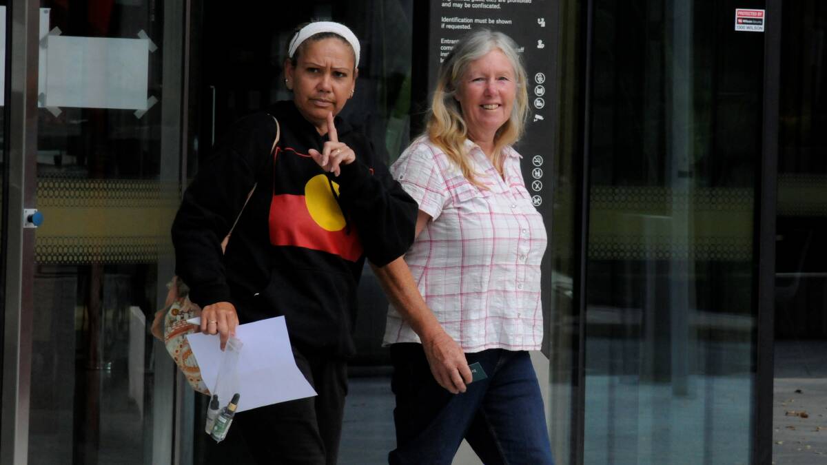 The "unknown lady", right, leaves court on Thursday after identifying herself only as Karen. Picture: Blake Foden
