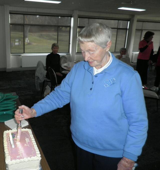 Peg cutting her 90th birthday cake at the Lithgow Golf Club. Picture: SUPPLIED. 