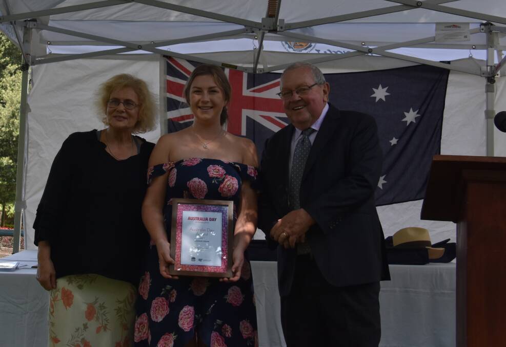 YOUNG CITIZEN: Shannon O'Regan (middle) with Australia Day Ambassador Susanne Gervay and Mayor Ray Thompson. Picture: KIM BASTOW