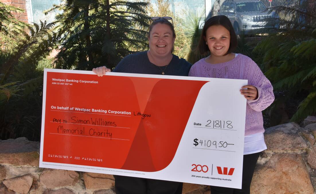 Renee Bradford with Keeley Collins and the cheque for the Simon Williams Memorial Foundation. 
