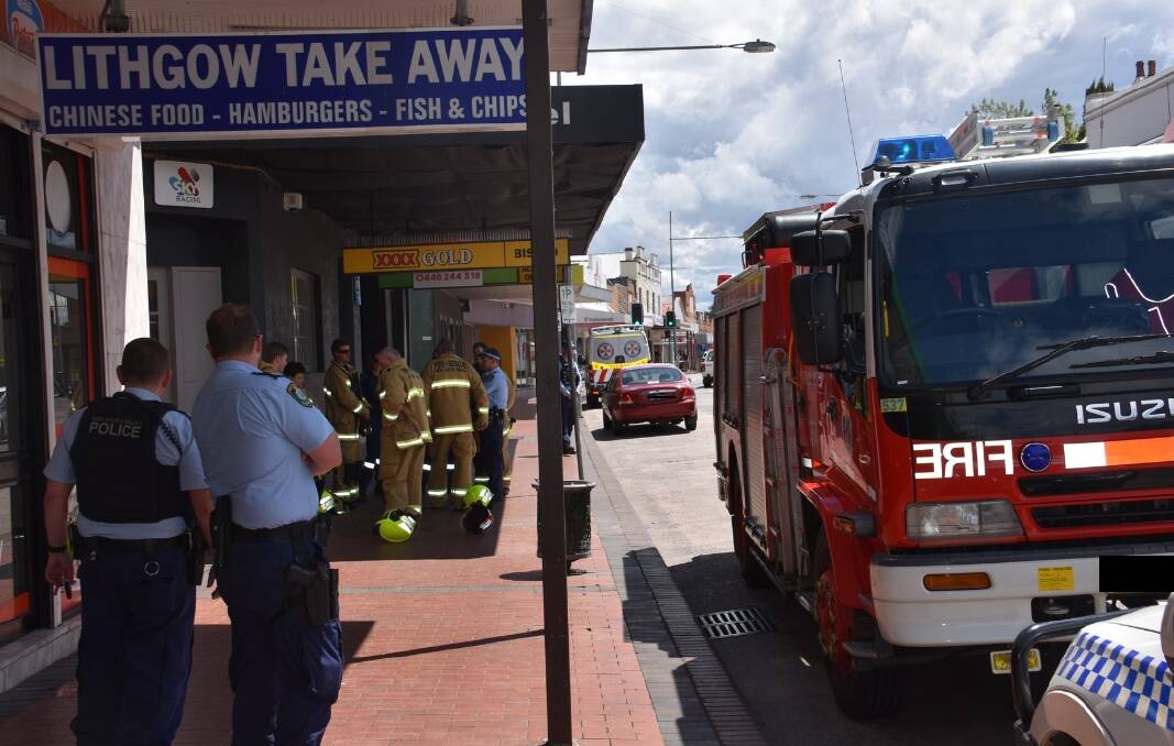 WAITING: Fire and Rescue crews and Lithgow Police instruct residents as they help put out electrical fire. Picture: CIARA BASTOW