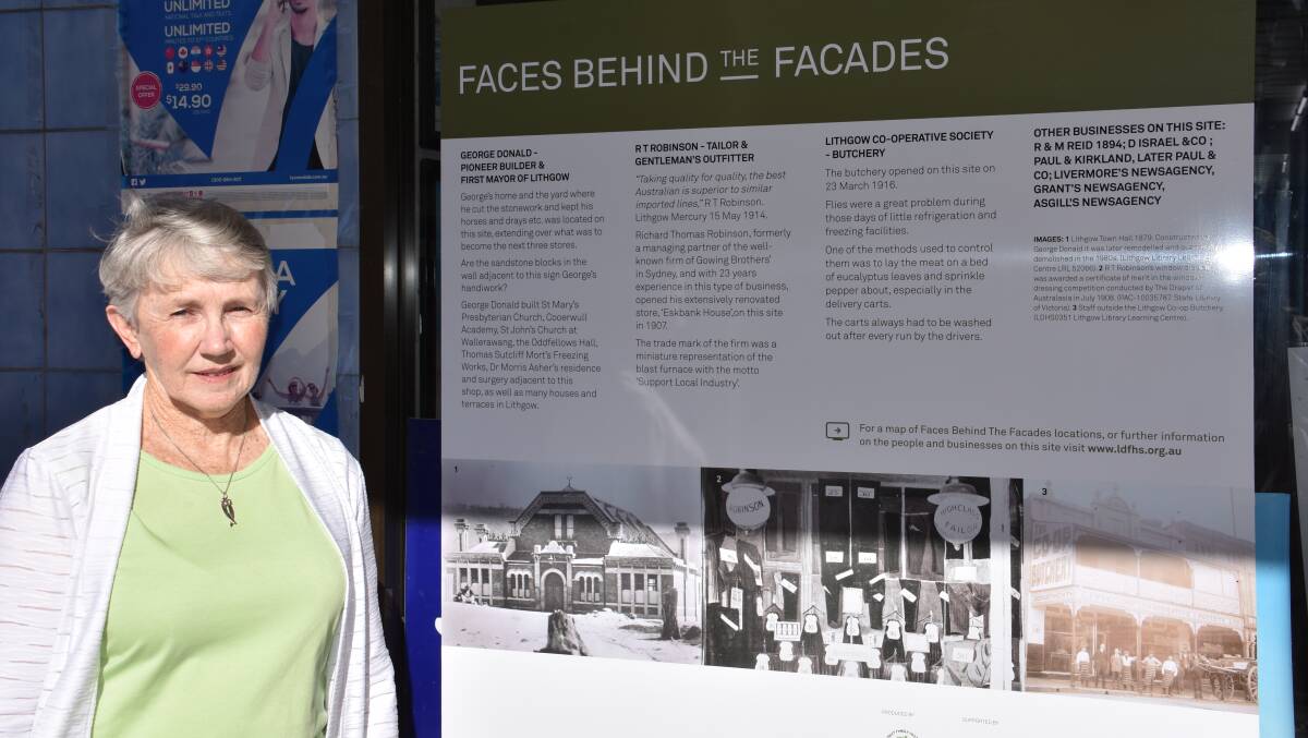 BUSINESS HISTORY: Jan Saundercock stands with one of the Faces behind the facades posters. Picture: CIARA BASTOW 