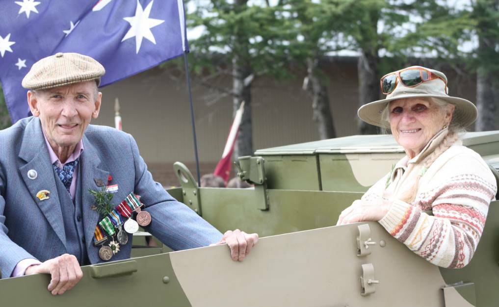 MARCH: Max Farr hitches a ride in a restored tank with Elma McKinnon. The tank they are riding in was restored by her son, Wayne Lane. 