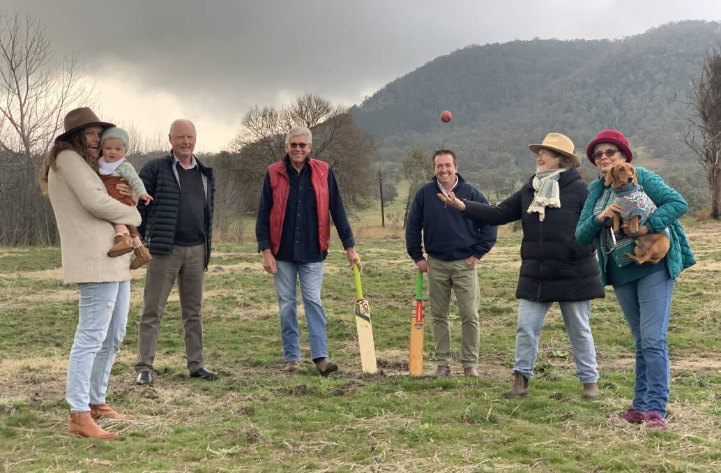 SIX HIT: Bathurst MP Paul Toole, third from right, at the Tarana Village Green after delivering the good news of its pending make-over with, from left: Louise Dargan and son Jack Pender, Greg Dargan, James Cook, Annie Cook, Jenny Dargan and pooch Alan. Picture: SUPPLIED