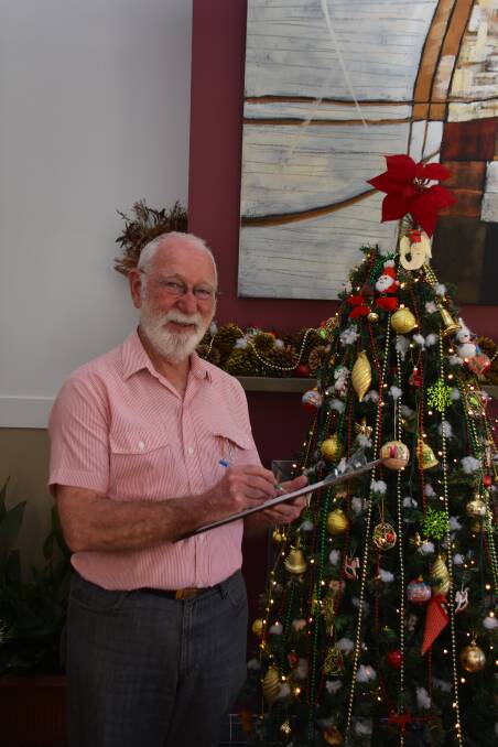 PETITION TIME: John Wiltshire with the petition that he has created for traffic lights at Col Drewe Drive intersection. Picture: CIARA BASTOW 