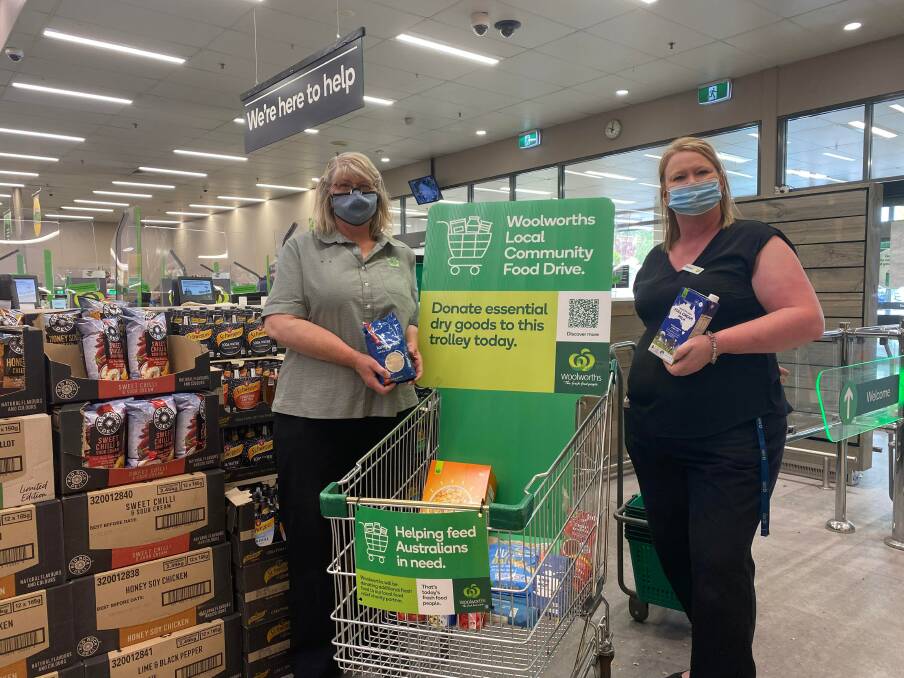 HELPING HANDS: Lithgow shop assistant Gloria Young and Assistant Shop Manager Sheridan Bryant stand together in front of the donation trolley. Photo: ALANNA TOMAZIN