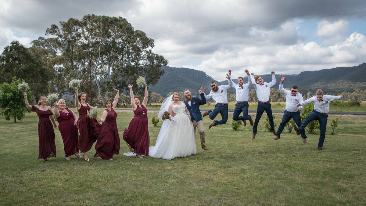 FUN: The wedding was a a lot of fun with the bridal party leaping into the air. Picture: Karen Edwards Photography