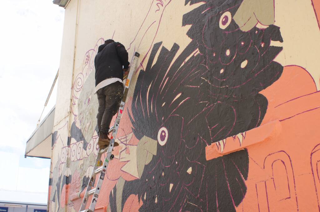 HARD WORK: Gerard Brown during the process of creating the mural. Picture: SUPPLIED. 