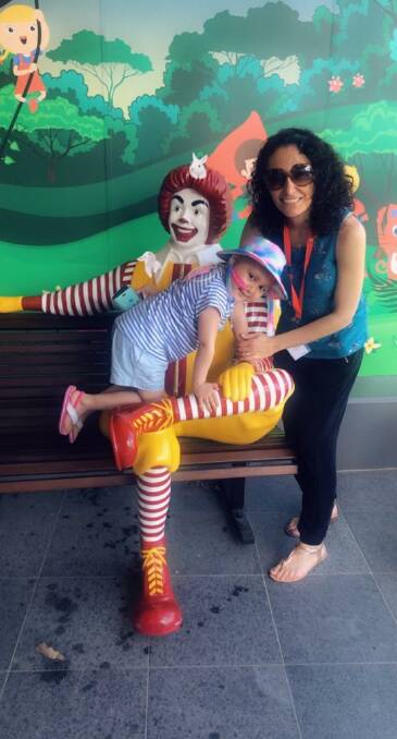 PLAYFUL: Angela with her mother Nikki climbing on the Ronald McDonald statue. Photo: SUPPLIED 