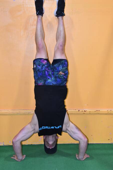 MUSCLE: Kable shows his strength while doing hand stand push ups. Picture: CIARA BASTOW. 