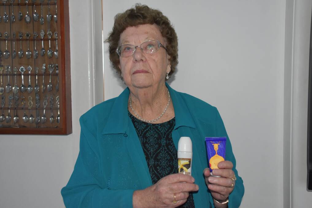 Doreen holding up some of the more common Avon products; hand creams and deodorants. 
