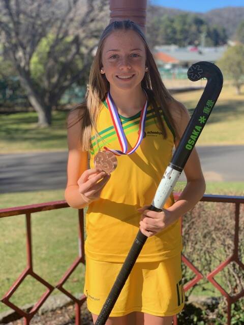 Emily, wearing the Australian colours, holds her bronze medal proudly. Picture: SUPPLIED. 