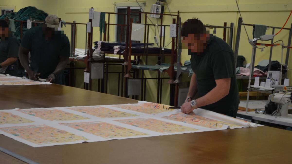 HARD WORK: Inmates work on the cutting, sewing and packaging of the tea towels. Photo: CIARA BASTOW 