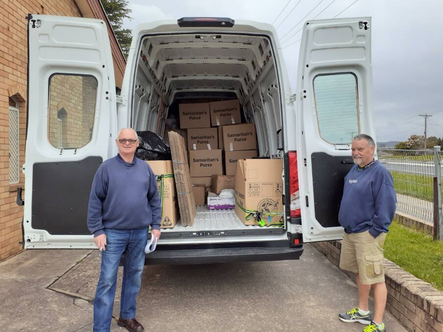 HELPING HANDS: Two volunteers called to pick up the results of the recent packing day. Photo: SUPPLIED 
