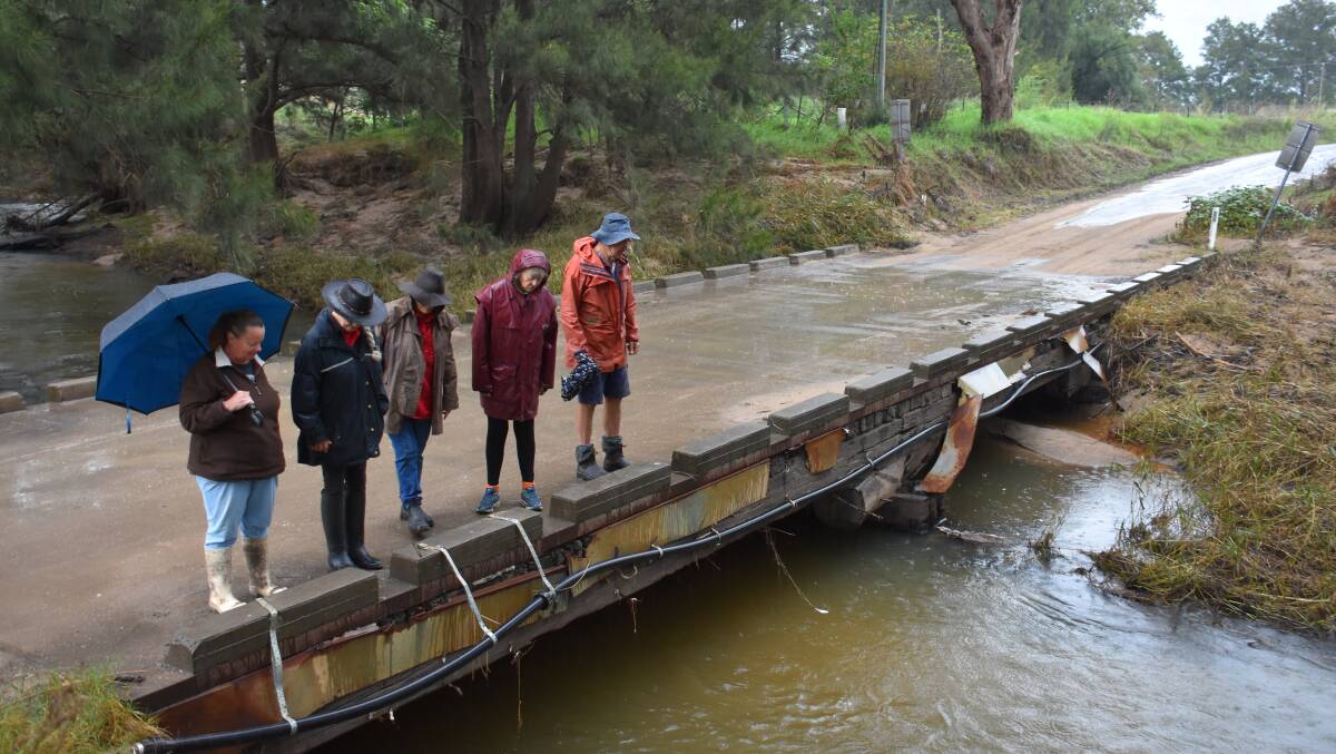 FEARS: Glen Davis residents Tygalily Keeley, Sue Todd, Julie Gibson, Jane Mills and David McKnight stand on Glen Davis bridge staring at the water that when rises traps the residents. Picture: CIARA BASTOW 
