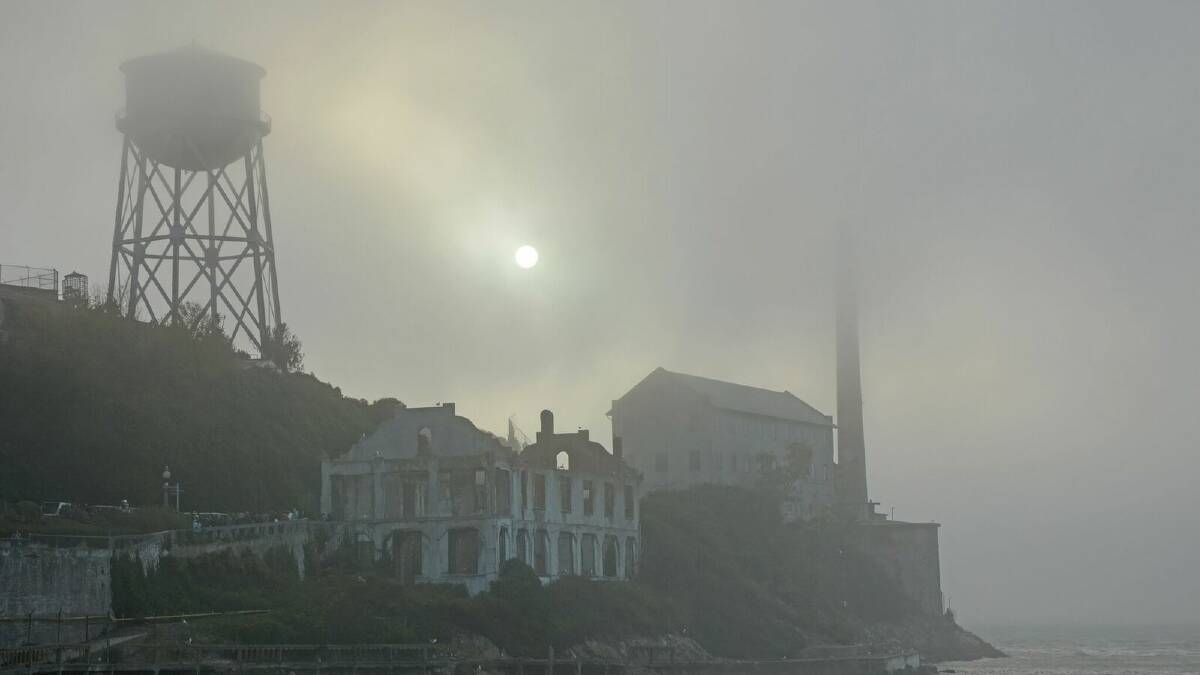 A spooky full moon peaks out on Alcatraz Island in San Fransisco 