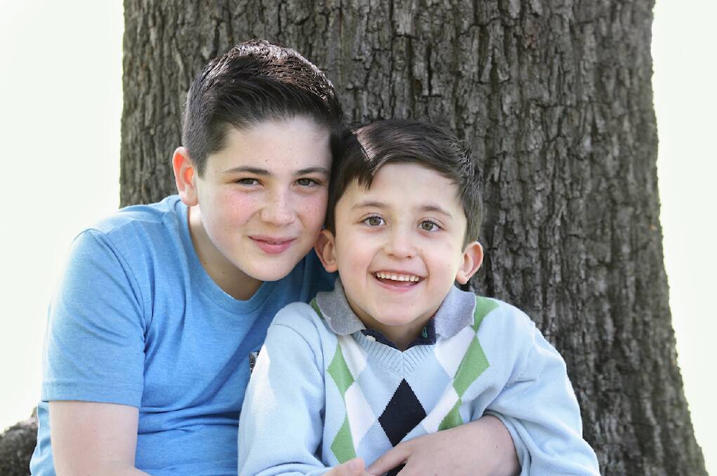 SUPPORT: Having regular access to weekly therapies and services means Alex, seen here with big brother Jonathan (left), has adjusted well to mainstream school and the family is no longer financially burdened.