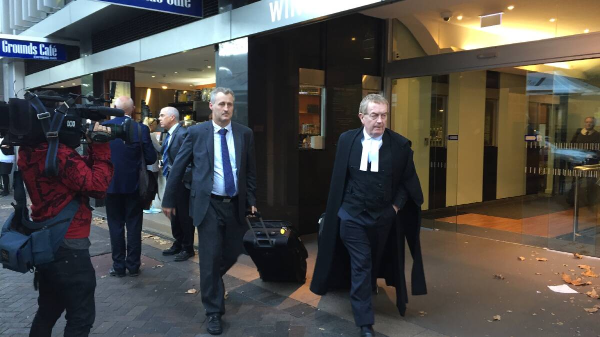IN COURT: EPA's legal representatives Eric Bateman and barrister Stephen Rushton SC exit the Land and Environment Court. 