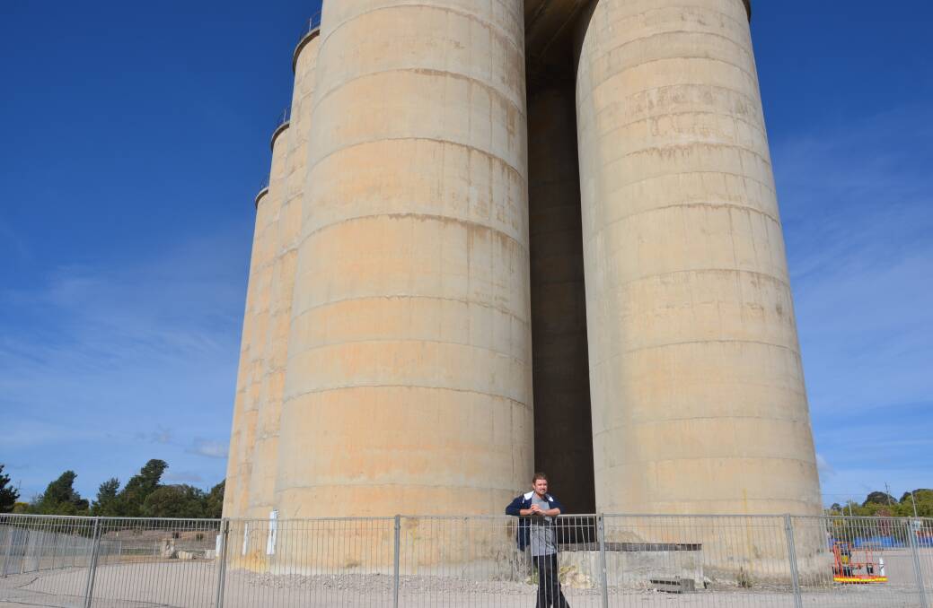 NO SMALL TASK: Guido van Helten in front of Portland's silos before beginning his mural on Sunday, April 15. Picture: PHOEBE MOLONEY. 