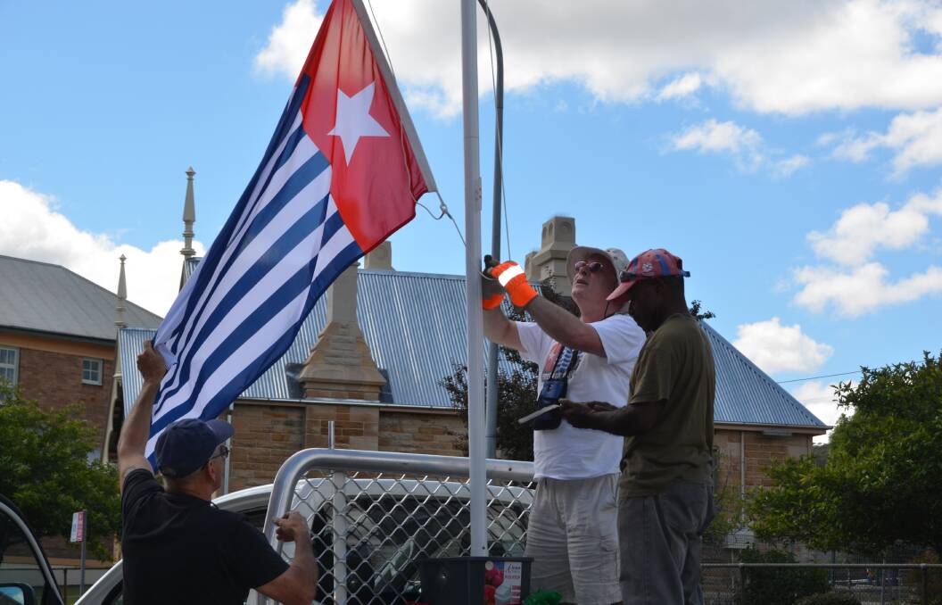 Patianus Kogoya, Roger Bowen and Lithgow's Anthony Craig raised the Morning Star flag of West Papua at the Lithgow City Council last year. Raising the flag in West Papua can result in imprisonment. Picture: HOSEA LUY