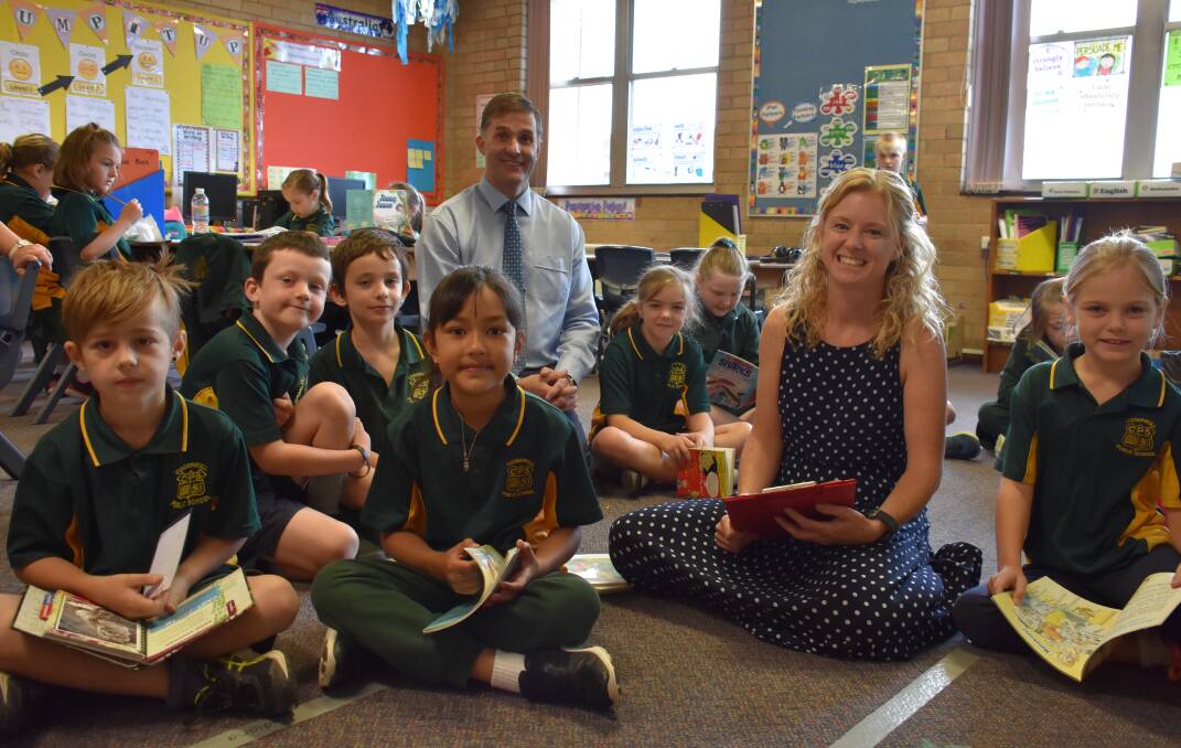 BOOK WORMS: Cooerwull class 3 Aqua during reading time with principal Mark Snow and teacher Natalie Van Der Velden. Picture: PHOEBE MOLONEY. 