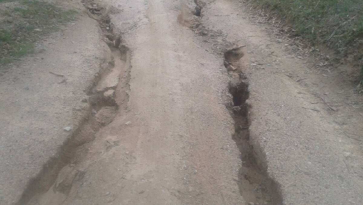 AFTER RAIN: Trenches that appeared in the road after heavy rainfall last year. Picture: SUPPLIED.